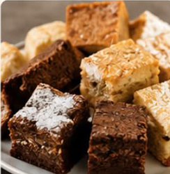 Close-up of chocolate brownies and dusted vanilla traybake squares